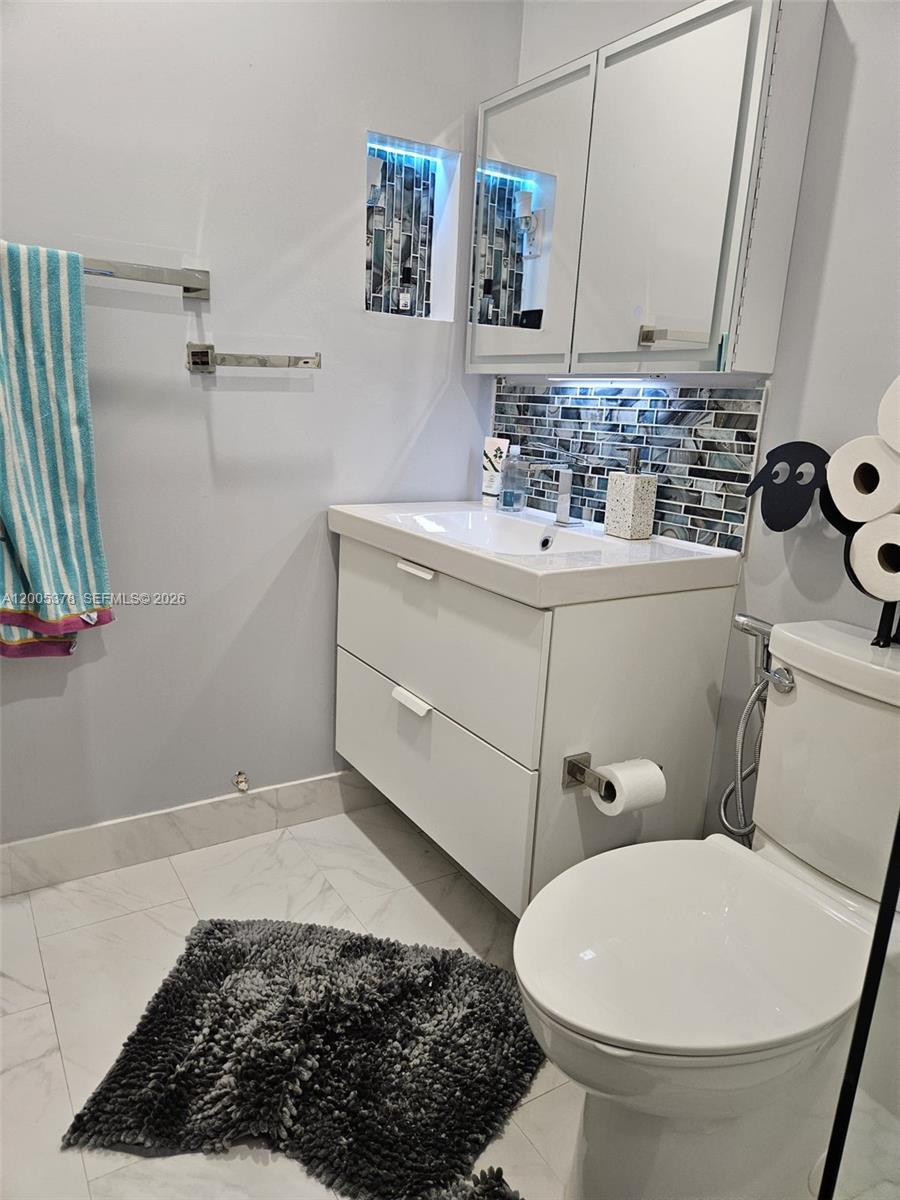16314 Southwest 97th Street Miami, FL 33196 - Photo 31 of 41 a bathroom with a sink a toilet and mirror