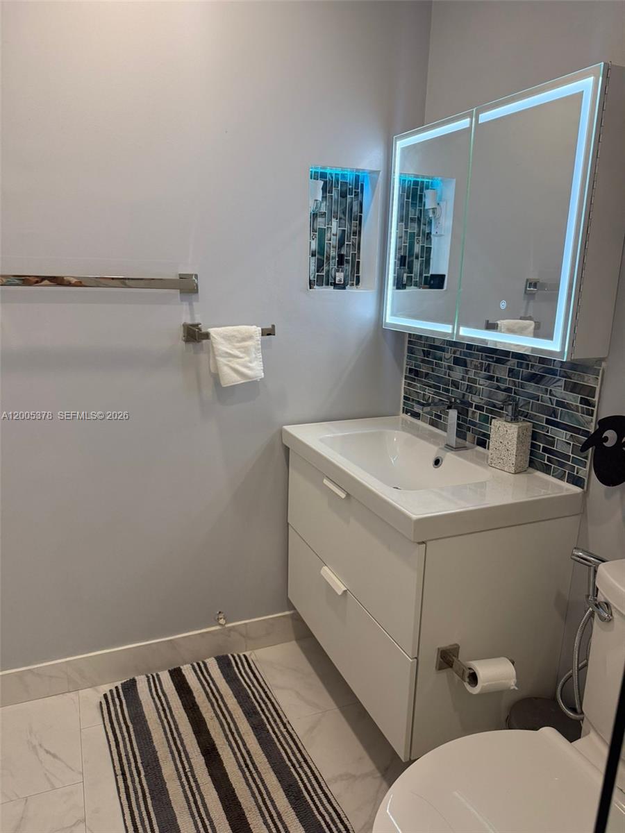 16314 Southwest 97th Street Miami, FL 33196 - Photo 33 of 41 a bathroom with a sink and a mirror