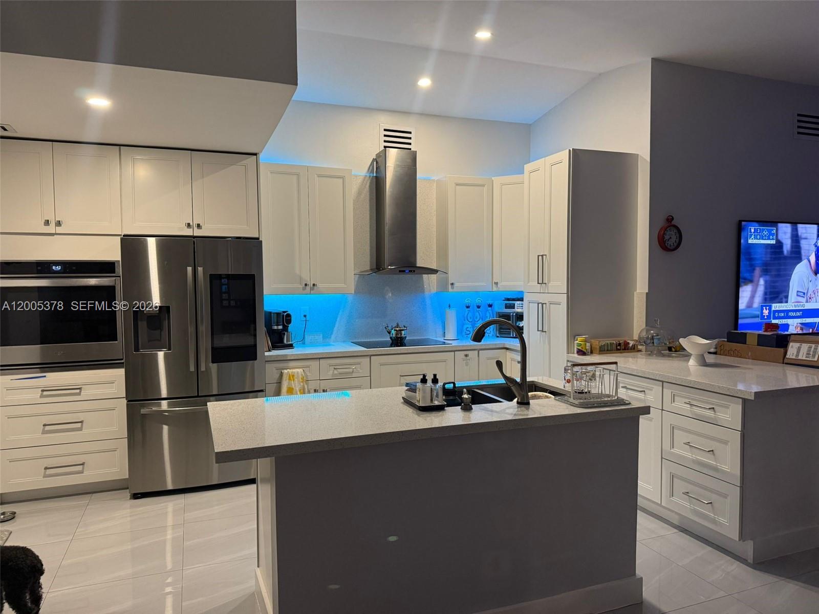 16314 Southwest 97th Street Miami, FL 33196 - Photo 4 of 41 a kitchen with stainless steel appliances a refrigerator sink and stove