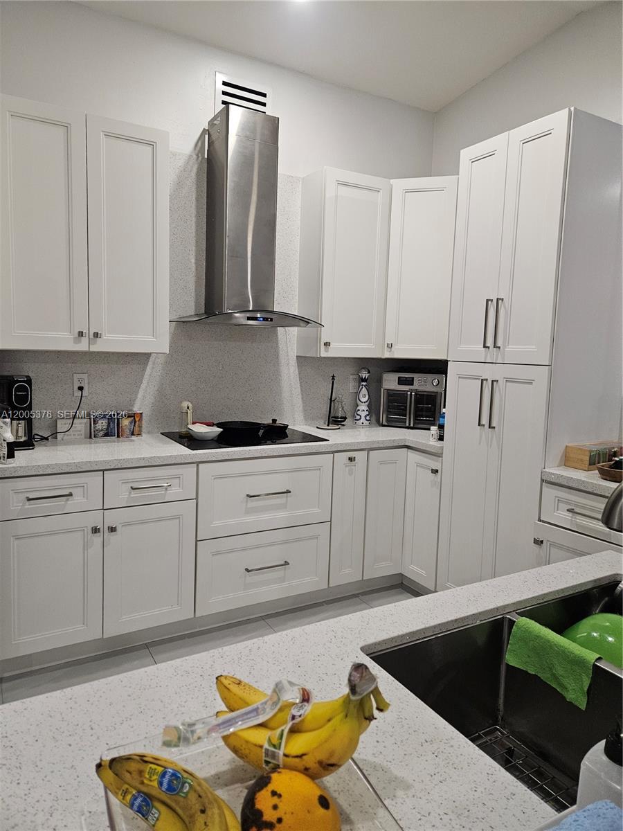 16314 Southwest 97th Street Miami, FL 33196 - Photo 5 of 41 a kitchen with appliances cabinets and a sink