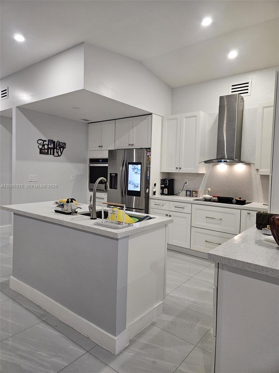 16314 Southwest 97th Street Miami, FL 33196 - Photo 7 of 41 a kitchen with stainless steel appliances granite countertop a sink and a stove