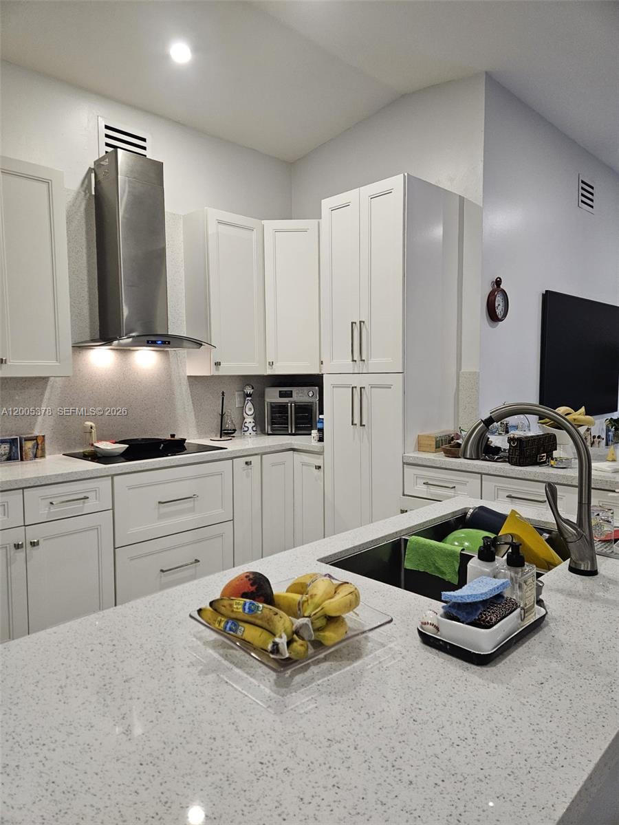 16314 Southwest 97th Street Miami, FL 33196 - Photo 8 of 41 a kitchen with kitchen island a cabinets a sink and appliances