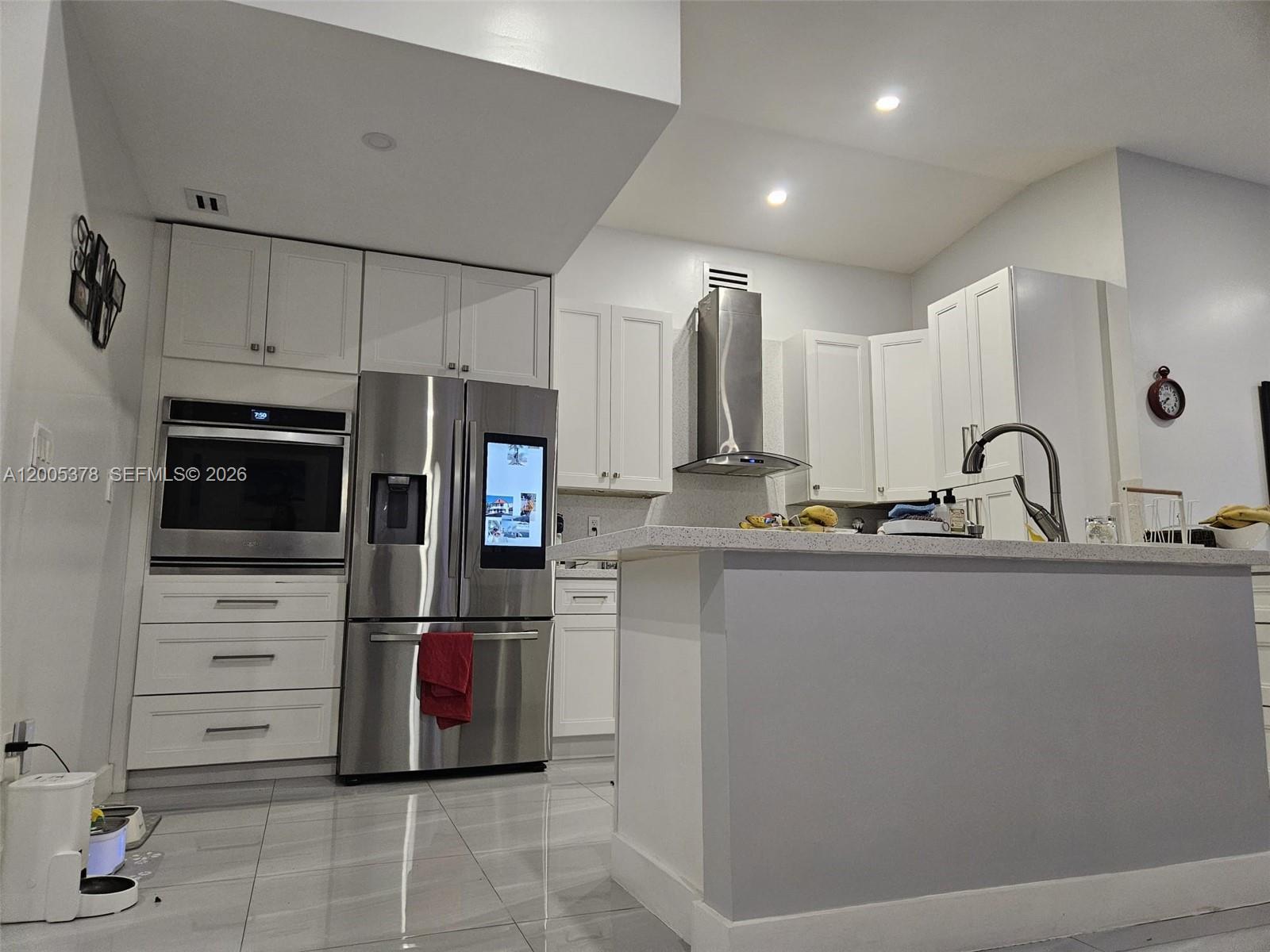 16314 Southwest 97th Street Miami, FL 33196 - Photo 9 of 41 a kitchen with refrigerator and cabinets