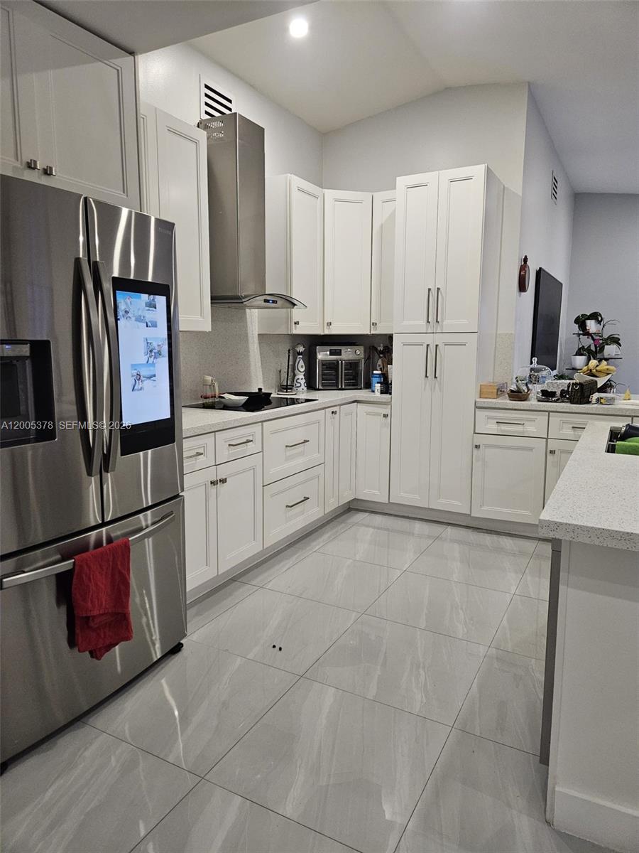 16314 Southwest 97th Street Miami, FL 33196 - Photo 10 of 41 a kitchen with stainless steel appliances granite countertop a refrigerator sink and cabinets