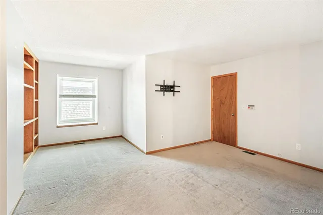 an empty room with windows and natural light