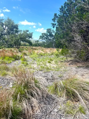 a backyard of a house with a yard and outdoor seating