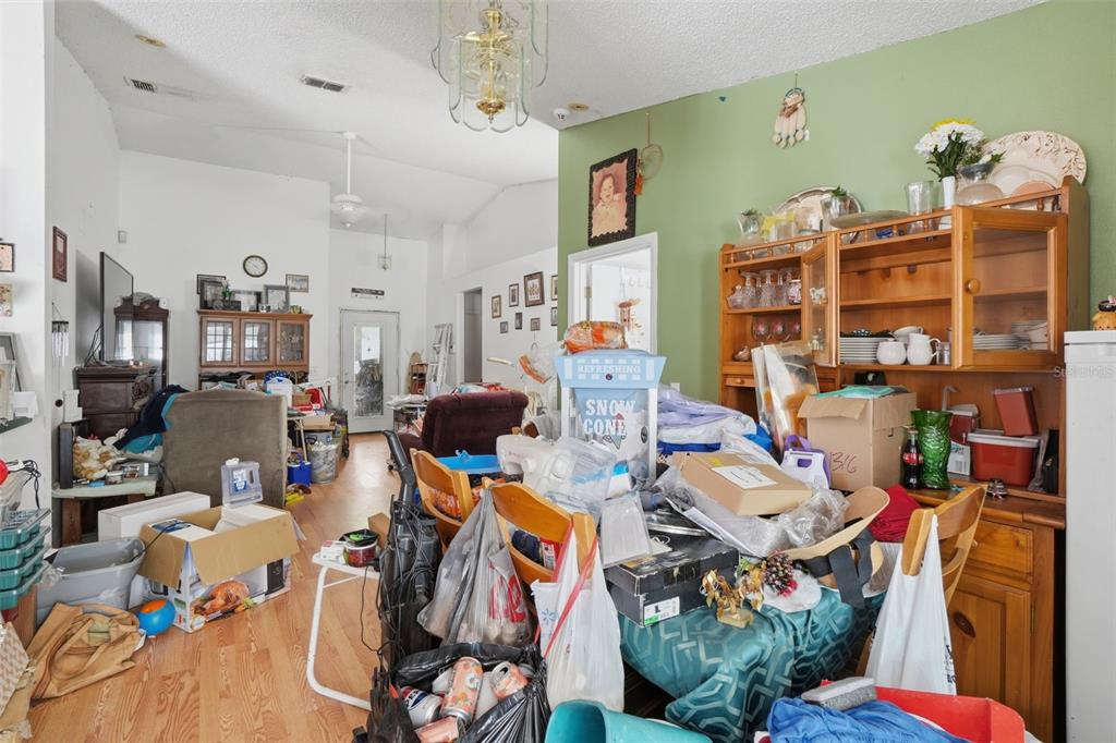 1650 East Welch Road Apopka, FL 32712 - Photo 11 of 29 a work room with lots of clutter and lots of furniture