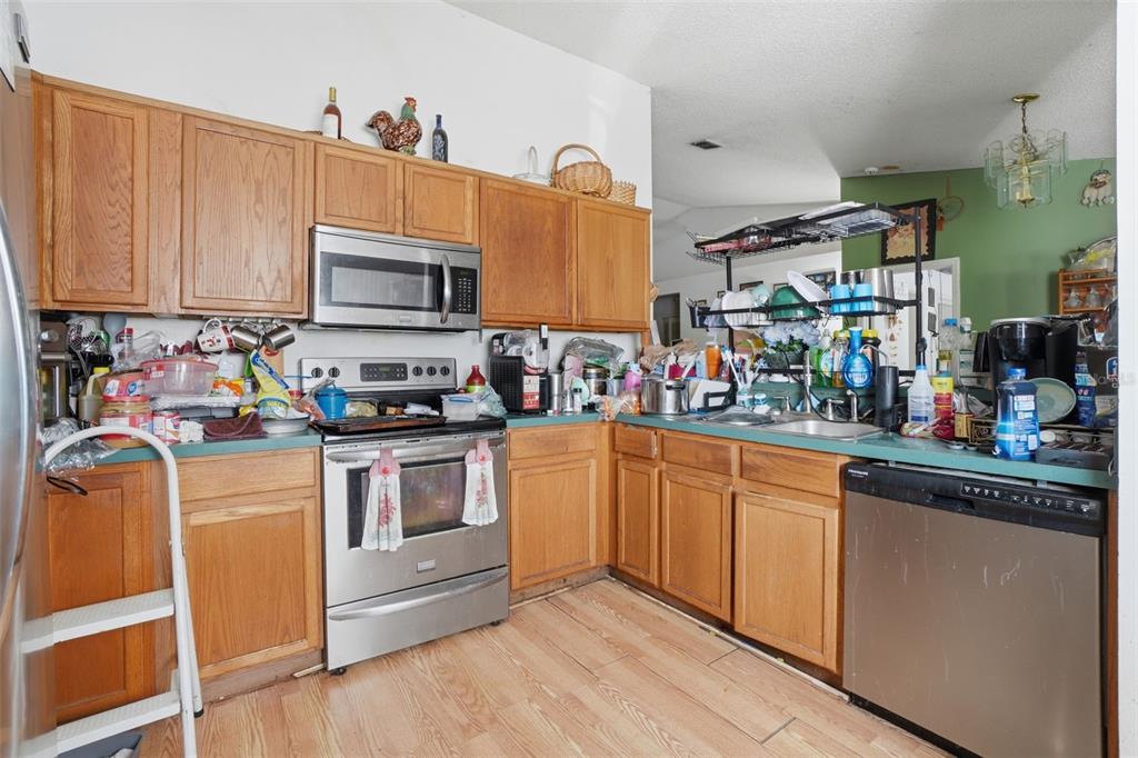 1650 East Welch Road Apopka, FL 32712 - Photo 14 of 29 a kitchen with stainless steel appliances granite countertop a refrigerator and microwave