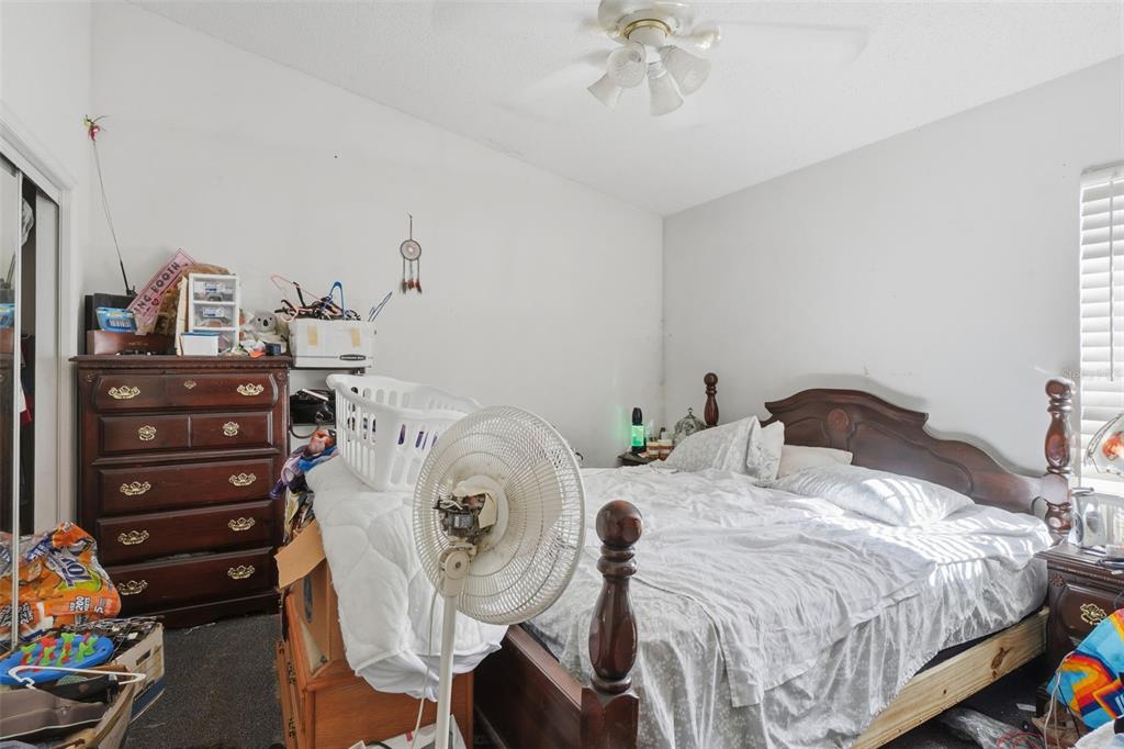 1650 East Welch Road Apopka, FL 32712 - Photo 16 of 29 a bedroom with a bed and a chandelier