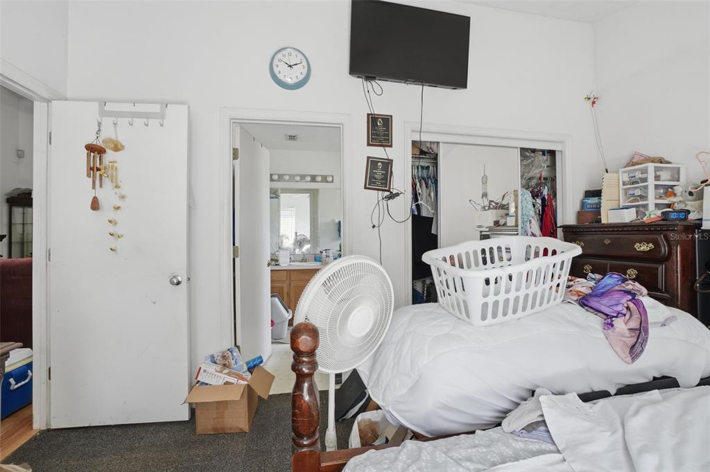 1650 East Welch Road Apopka, FL 32712 - Photo 17 of 29 a bedroom with furniture and a tv