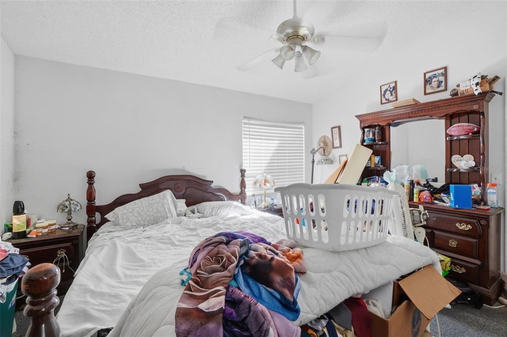 1650 East Welch Road Apopka, FL 32712 - Photo 18 of 29 a bedroom with two beds and a dresser