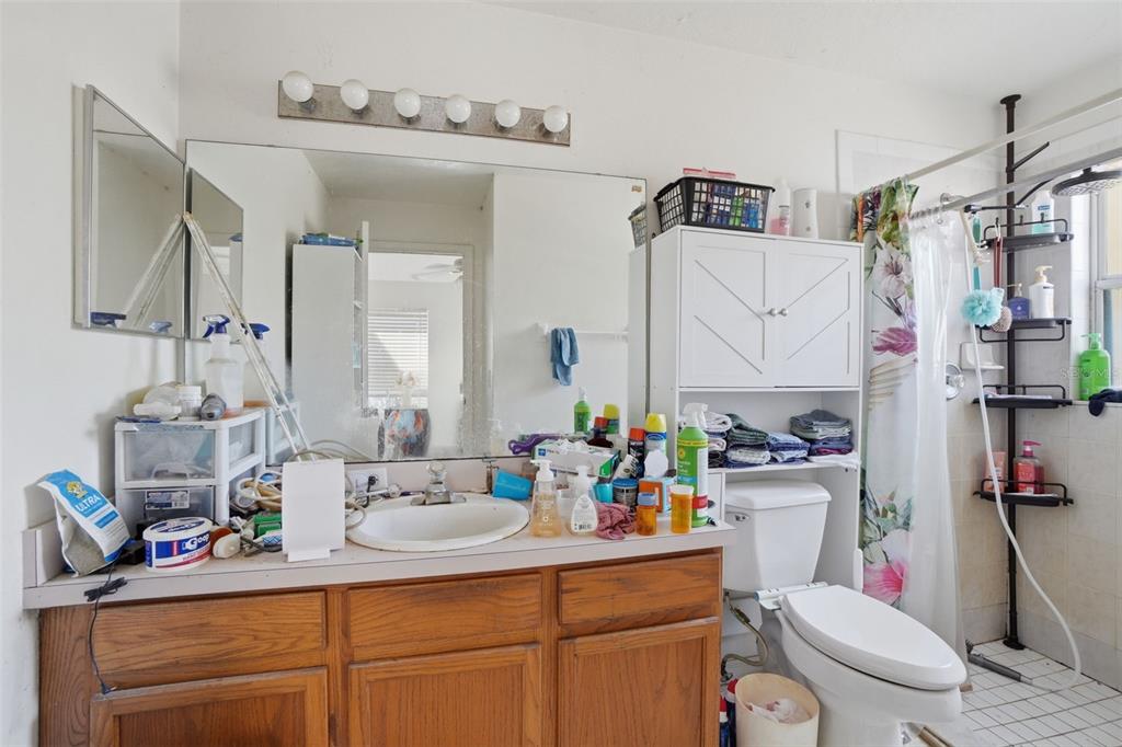 1650 East Welch Road Apopka, FL 32712 - Photo 19 of 29 a bathroom with a sink a toilet and a mirror