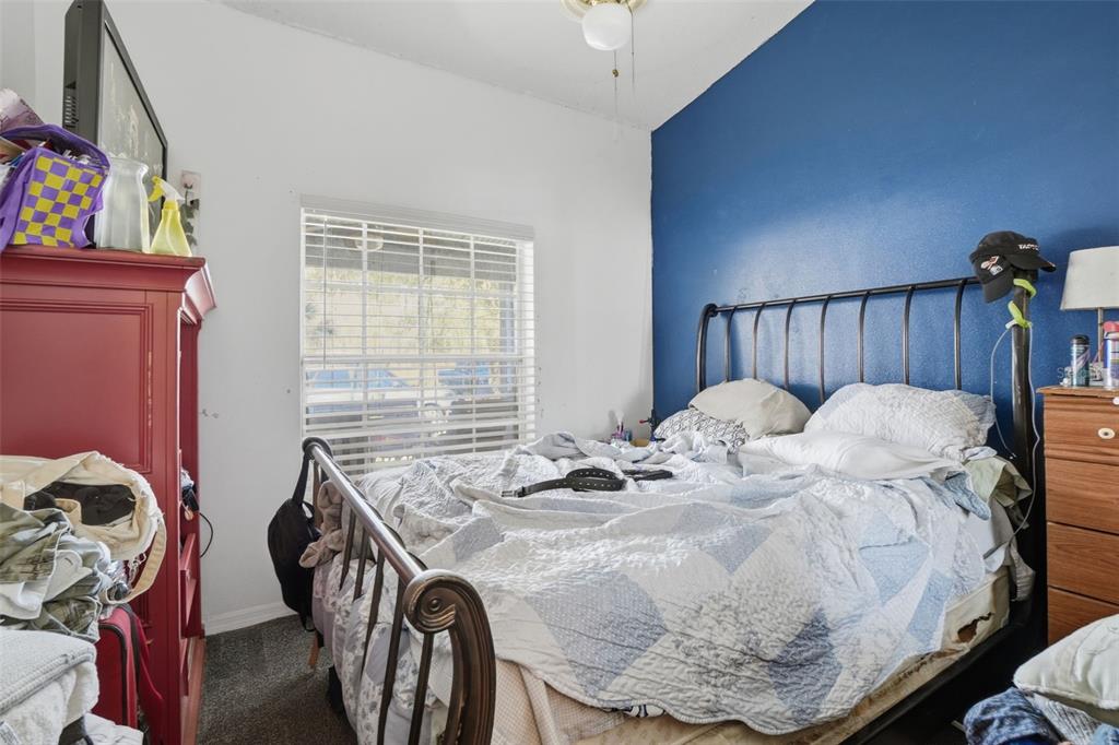 1650 East Welch Road Apopka, FL 32712 - Photo 20 of 29 a bed sitting in a bedroom next to a window