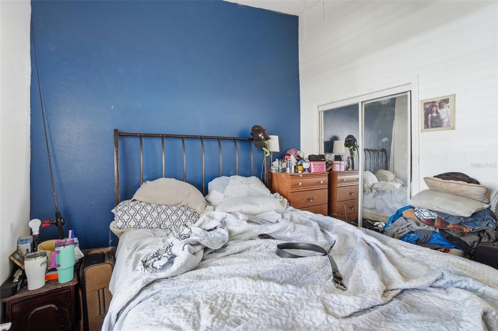 1650 East Welch Road Apopka, FL 32712 - Photo 21 of 29 a bed sitting in a bedroom and dresser with mirror