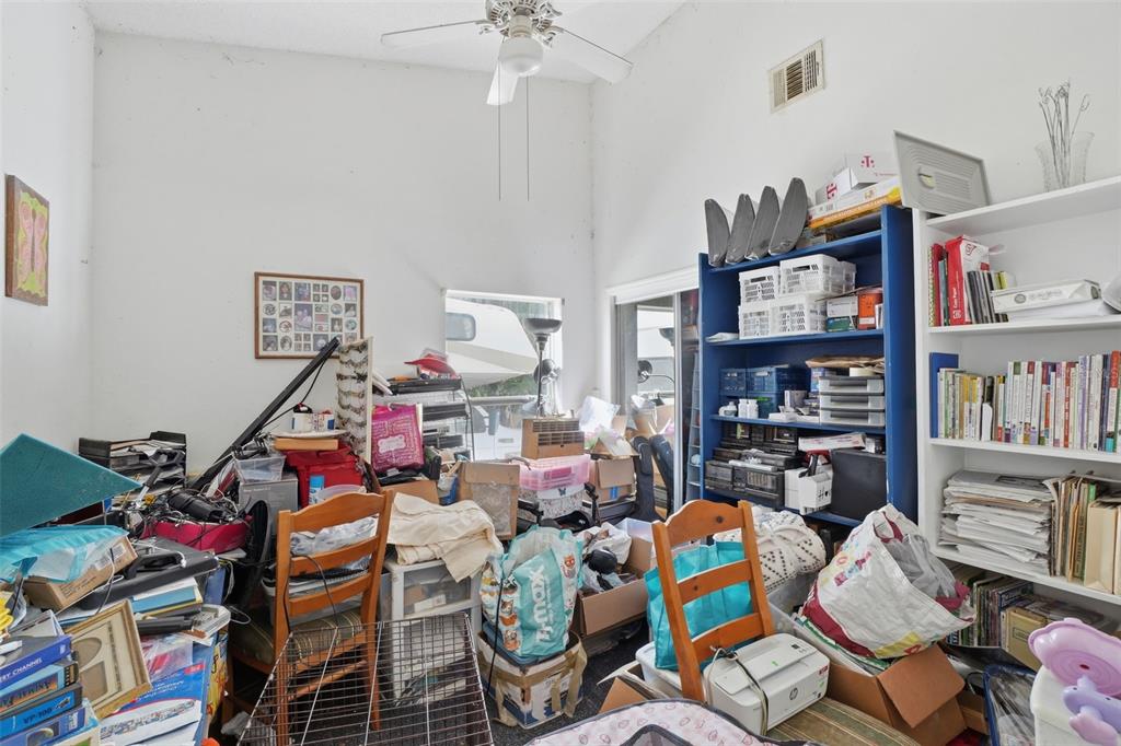 1650 East Welch Road Apopka, FL 32712 - Photo 23 of 29 a workspace with furniture and a book shelf