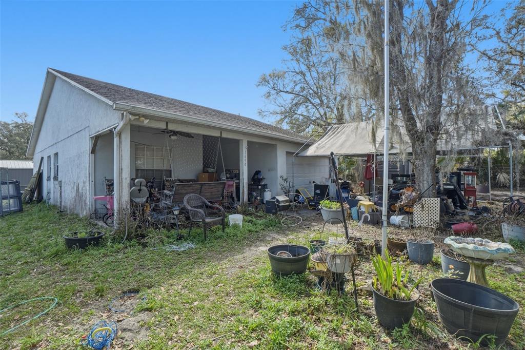 1650 East Welch Road Apopka, FL 32712 - Photo 5 of 29 a view of a backyard with plants and a patio