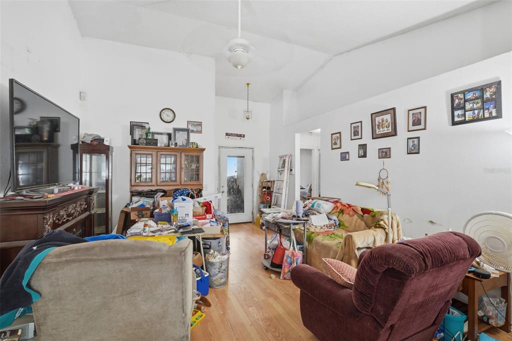 1650 East Welch Road Apopka, FL 32712 - Photo 8 of 29 a living room with furniture and a flat screen tv
