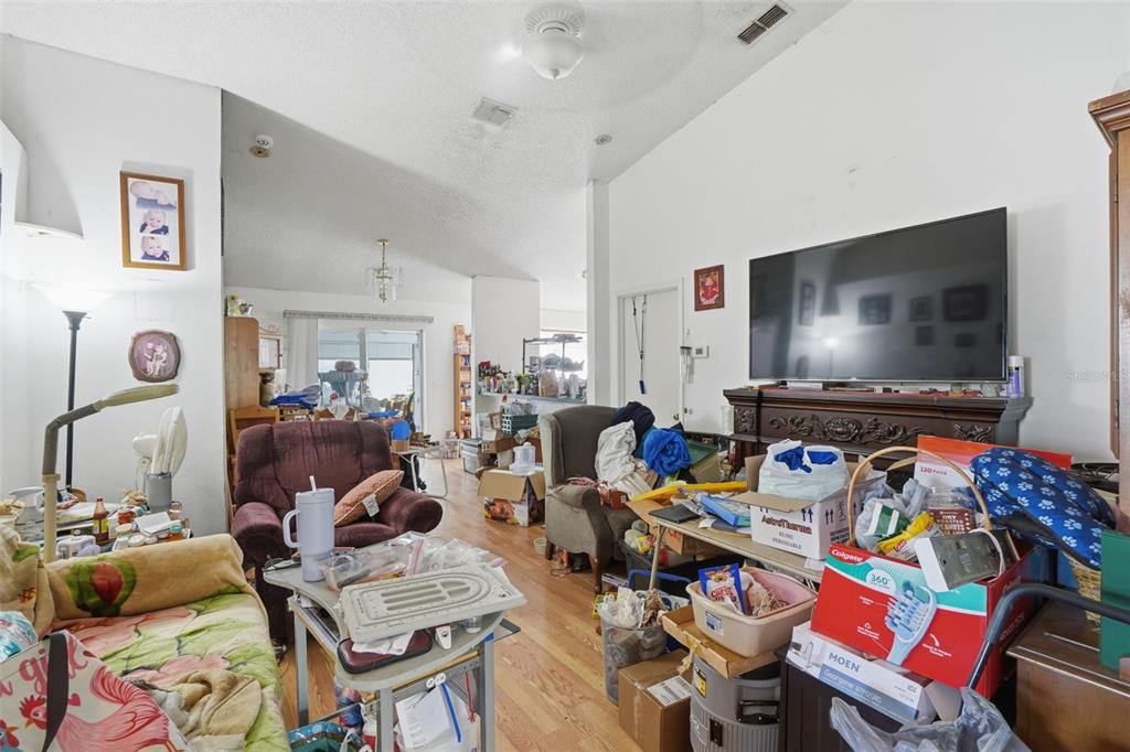 1650 East Welch Road Apopka, FL 32712 - Photo 9 of 29 a living room with furniture and a flat screen tv
