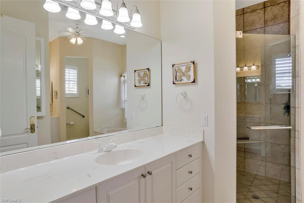 134 Windward Cay Naples, FL 34114 - Photo 17 of 35 a bathroom with a sink vanity and shower
