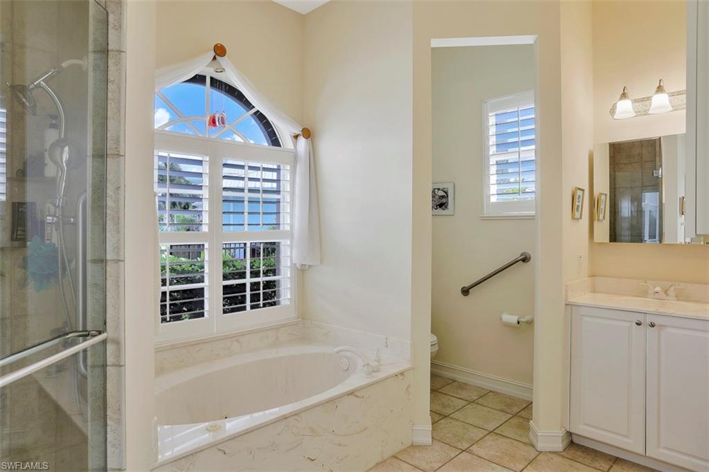 134 Windward Cay Naples, FL 34114 - Photo 18 of 35 a bathroom with a bathtub and a shower
