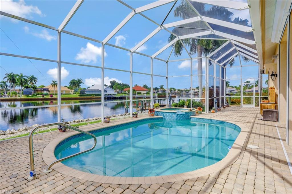 134 Windward Cay Naples, FL 34114 - Photo 19 of 35 a view of a swimming pool with a patio