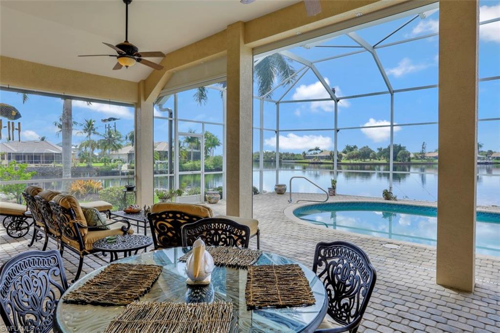 134 Windward Cay Naples, FL 34114 - Photo 2 of 35 a living room with furniture and a floor to ceiling window