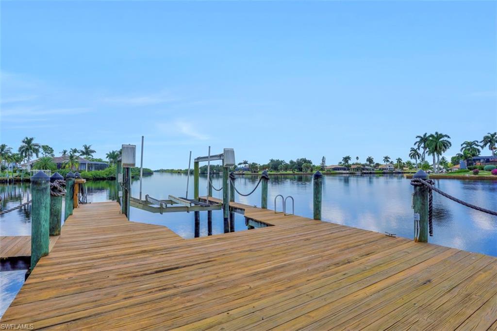 134 Windward Cay Naples, FL 34114 - Photo 23 of 35 a lake view with a table and chairs