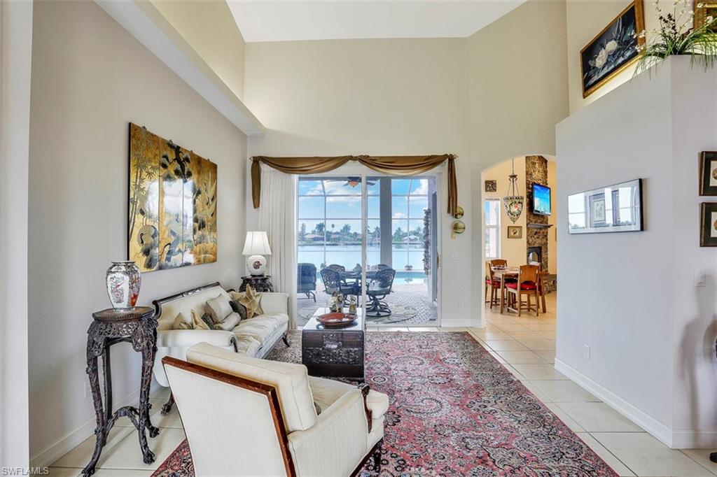 134 Windward Cay Naples, FL 34114 - Photo 25 of 35 a living room with furniture and a large window