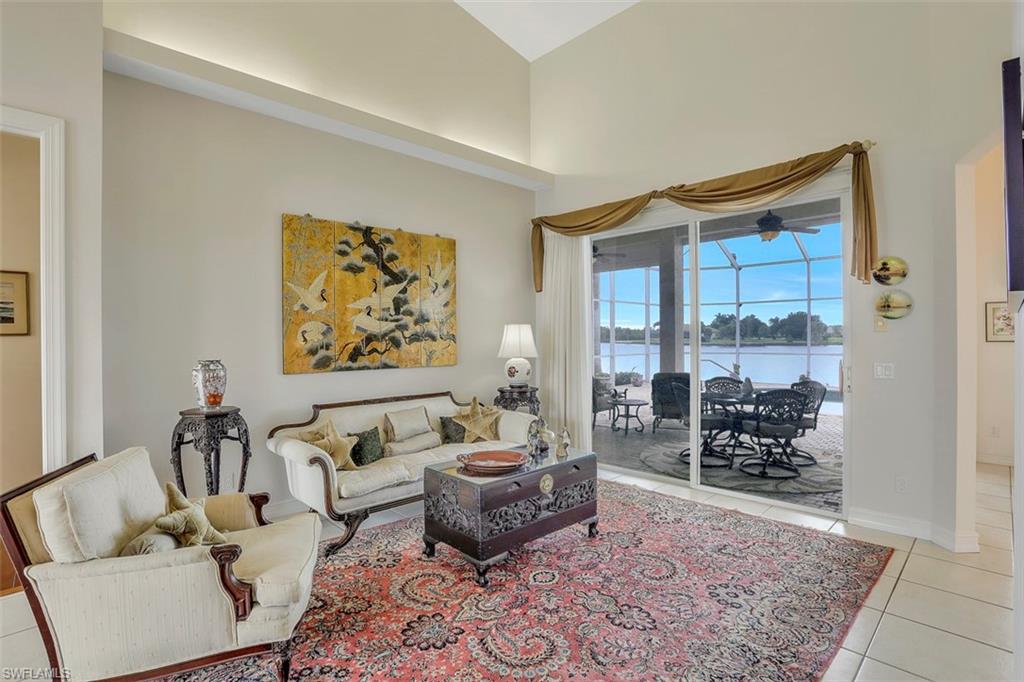 134 Windward Cay Naples, FL 34114 - Photo 26 of 35 a living room with furniture and a rug