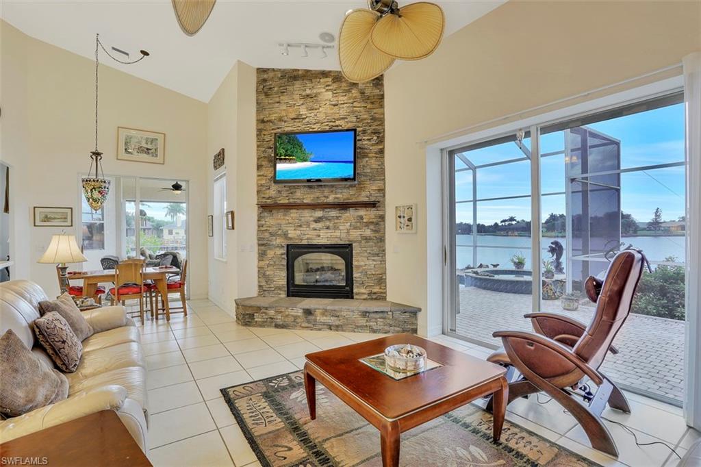 134 Windward Cay Naples, FL 34114 - Photo 30 of 35 a living room with furniture and a fireplace