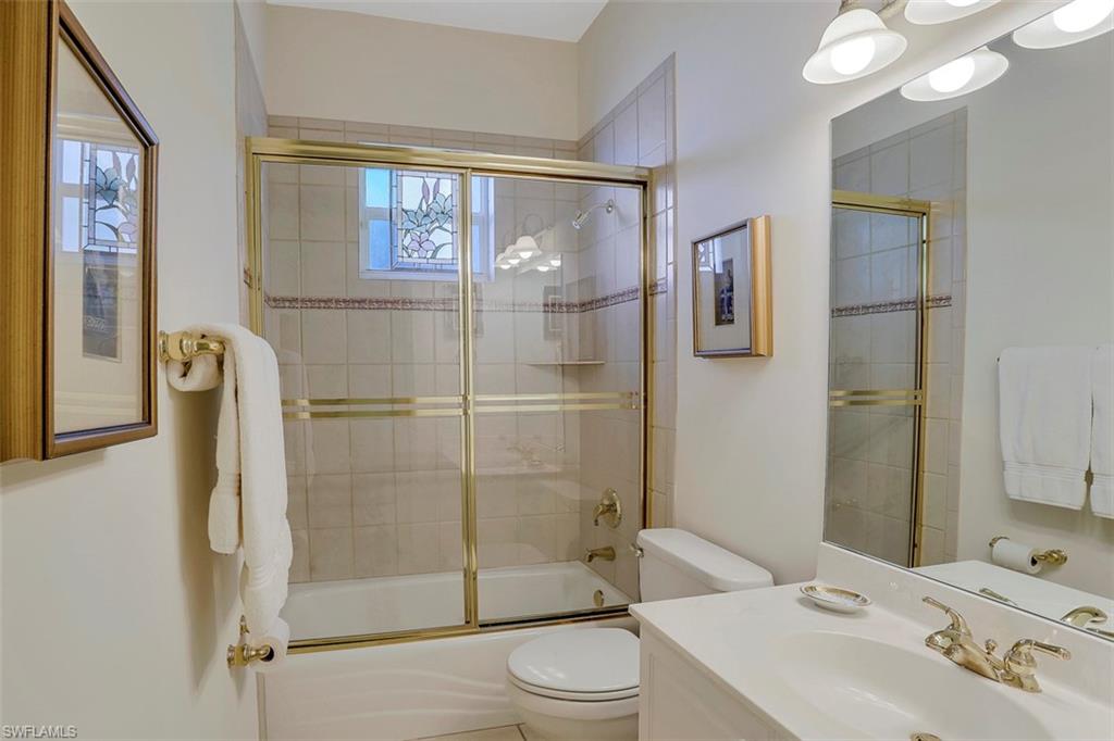 134 Windward Cay Naples, FL 34114 - Photo 32 of 35 a bathroom with a sink toilet and shower