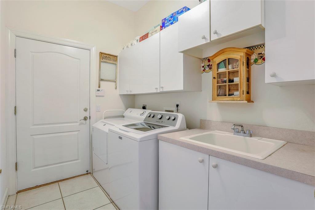 134 Windward Cay Naples, FL 34114 - Photo 33 of 35 a view of a sink and dishwasher with white cabinets