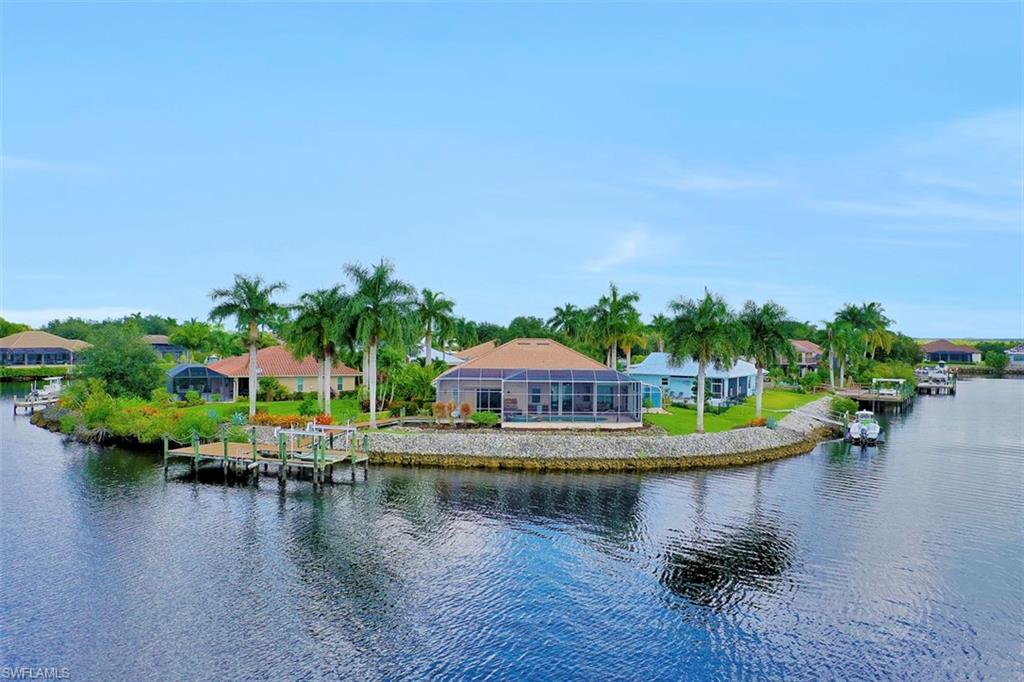 134 Windward Cay Naples, FL 34114 - Photo 7 of 35 a view of a lake with houses in back