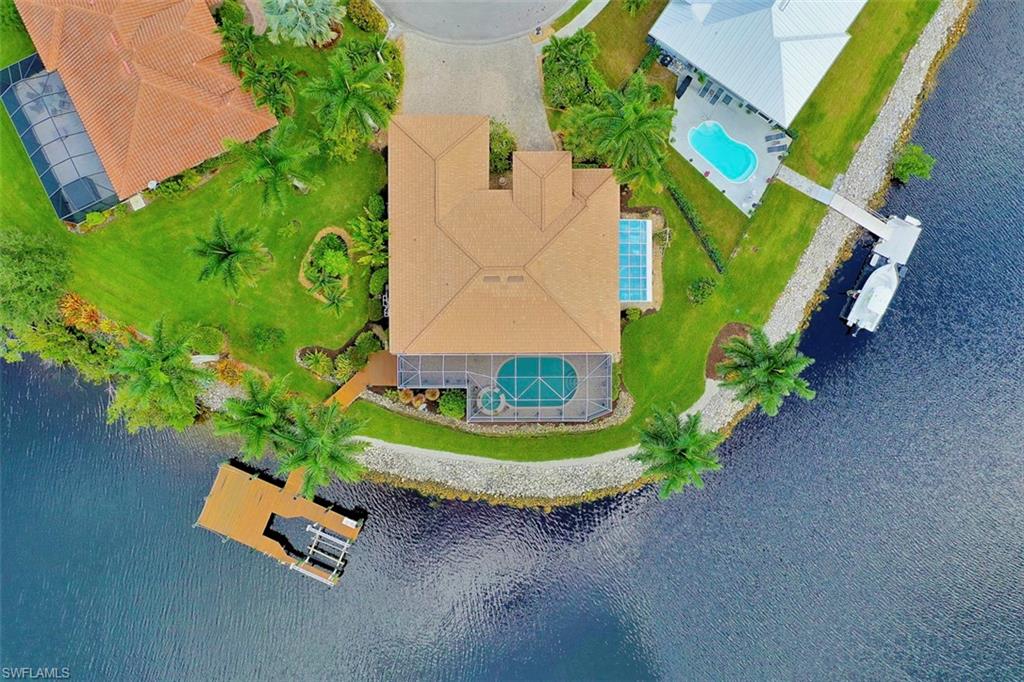 134 Windward Cay Naples, FL 34114 - Photo 10 of 35 an aerial view of a house with a garden and trees