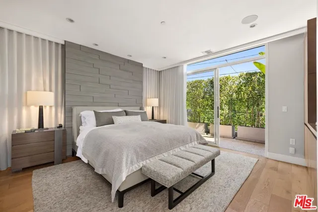 a bedroom with a bed and large window