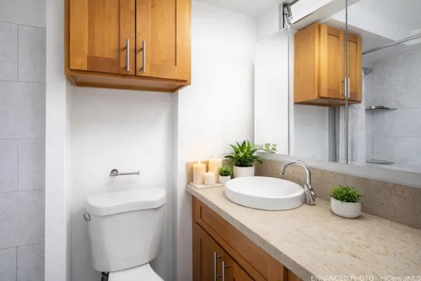 a bathroom with a granite countertop sink and a mirror