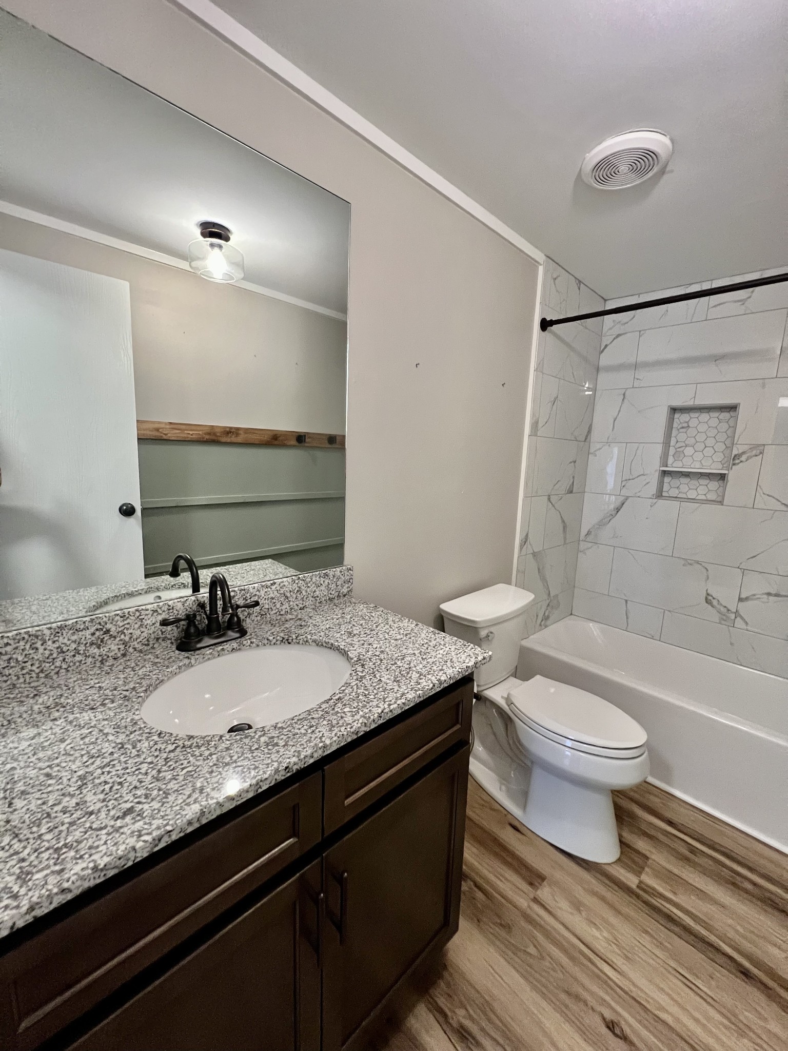 114 Barber Road Unionville, TN 37180 - Photo 24 of 36 a bathroom with a granite countertop toilet sink and mirror