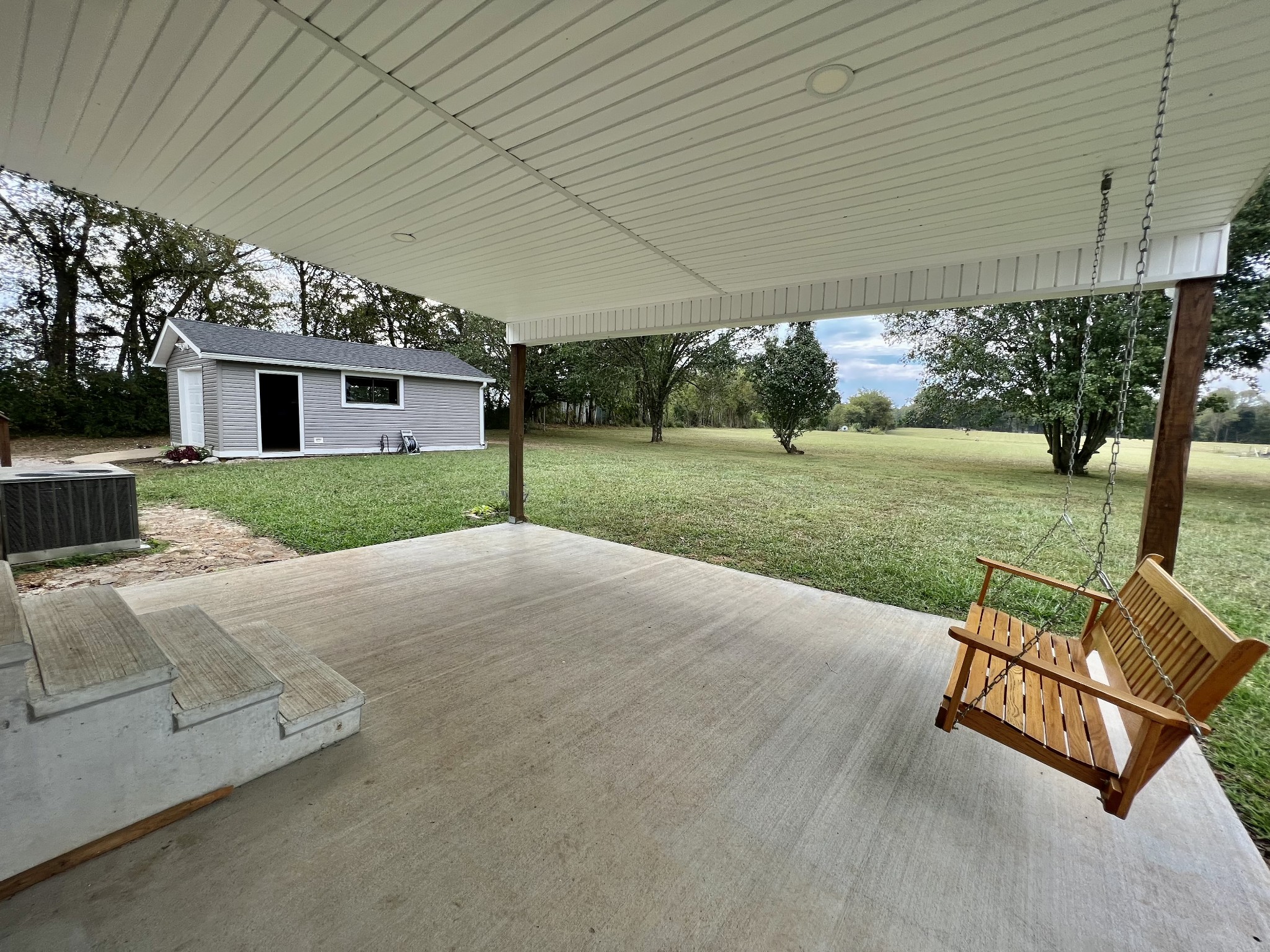 114 Barber Road Unionville, TN 37180 - Photo 33 of 36 a view of a backyard with couches under an umbrella