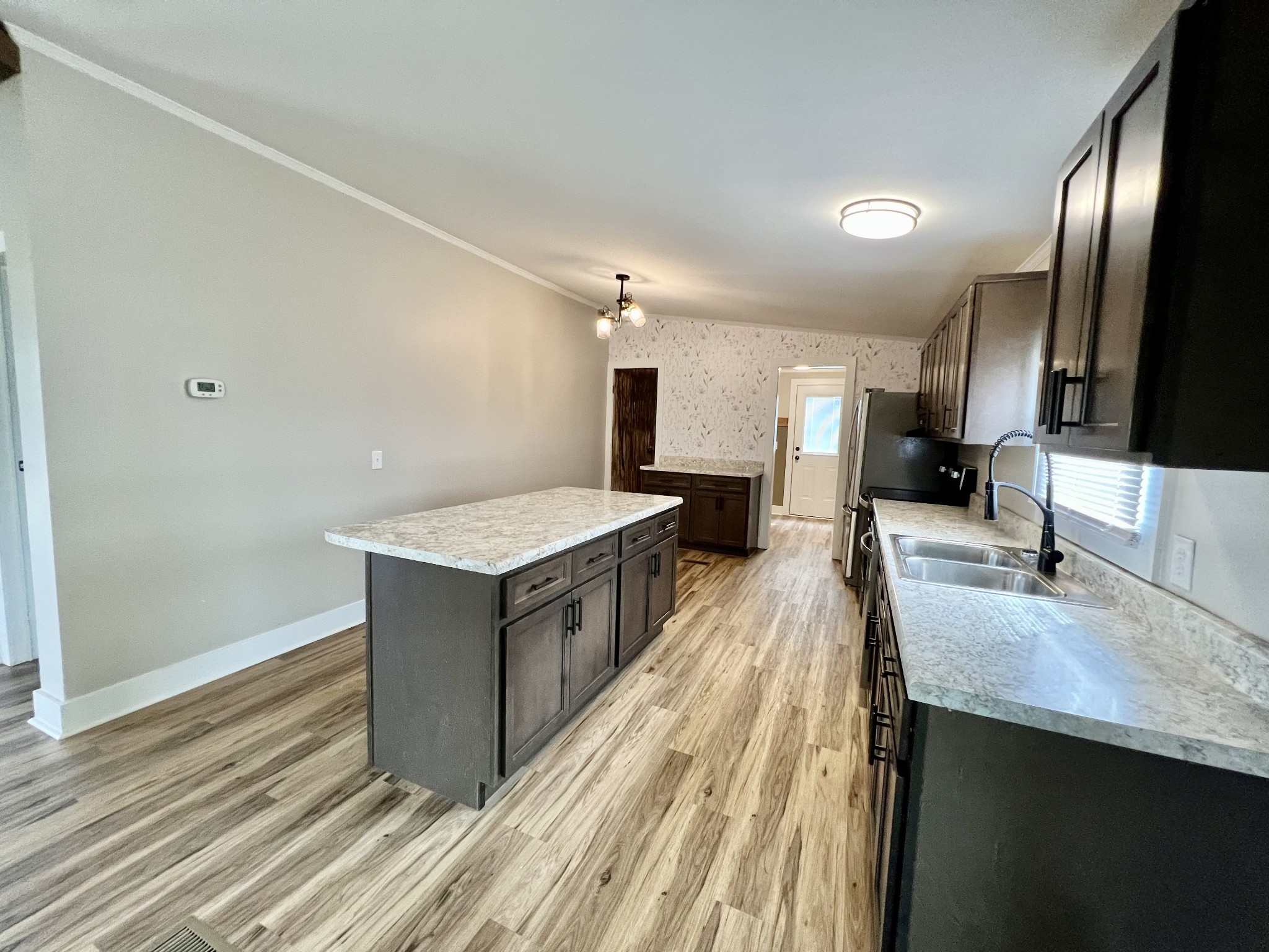 114 Barber Road Unionville, TN 37180 - Photo 9 of 36 a large kitchen with a center island and stainless steel appliances
