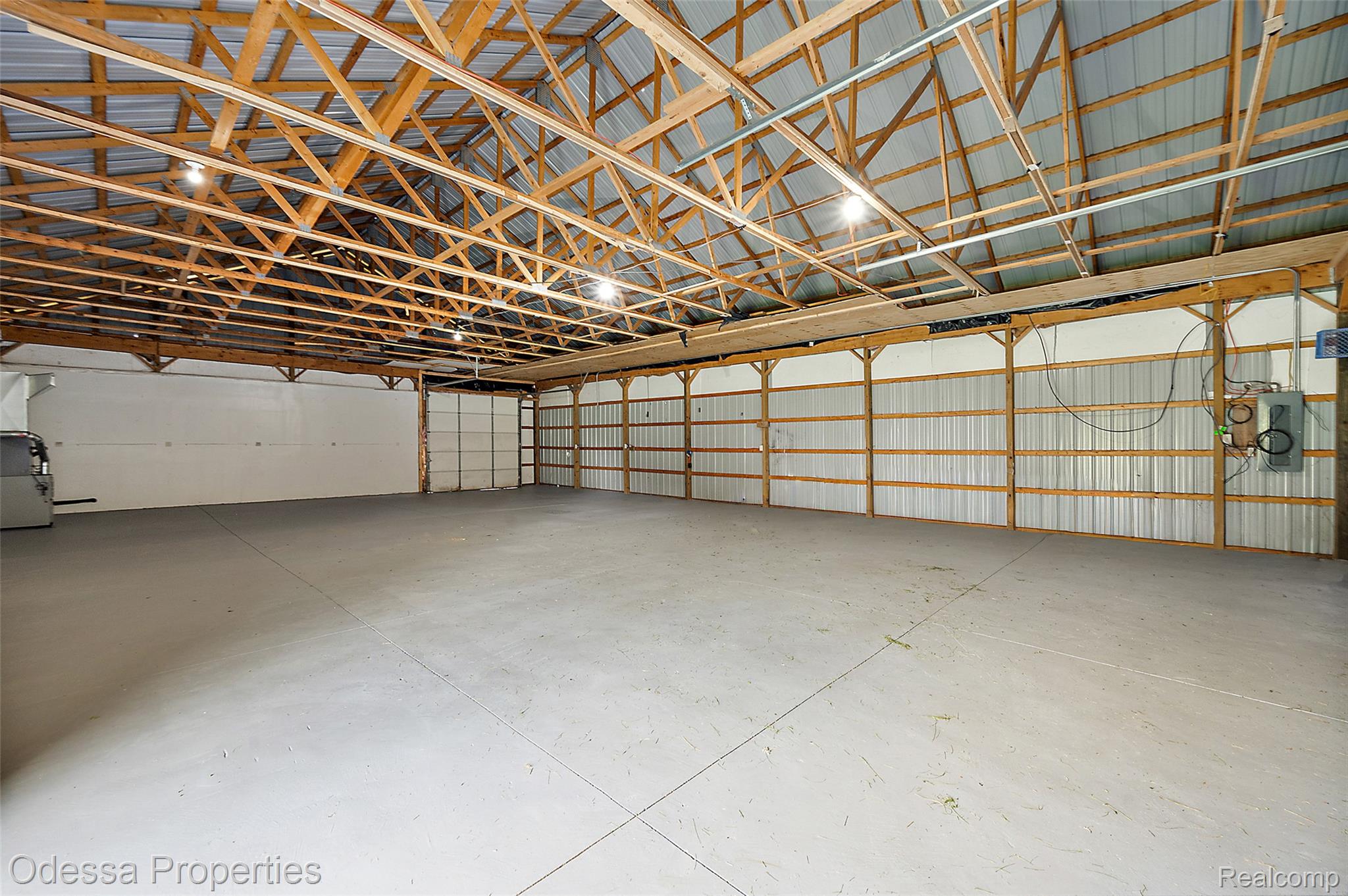 1442 Riley Center Road Memphis, MI 48041 - Photo 46 of 62 Garage featuring metal wall, electric panel, and heating unit