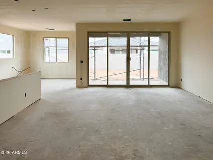 an empty room with windows and closet