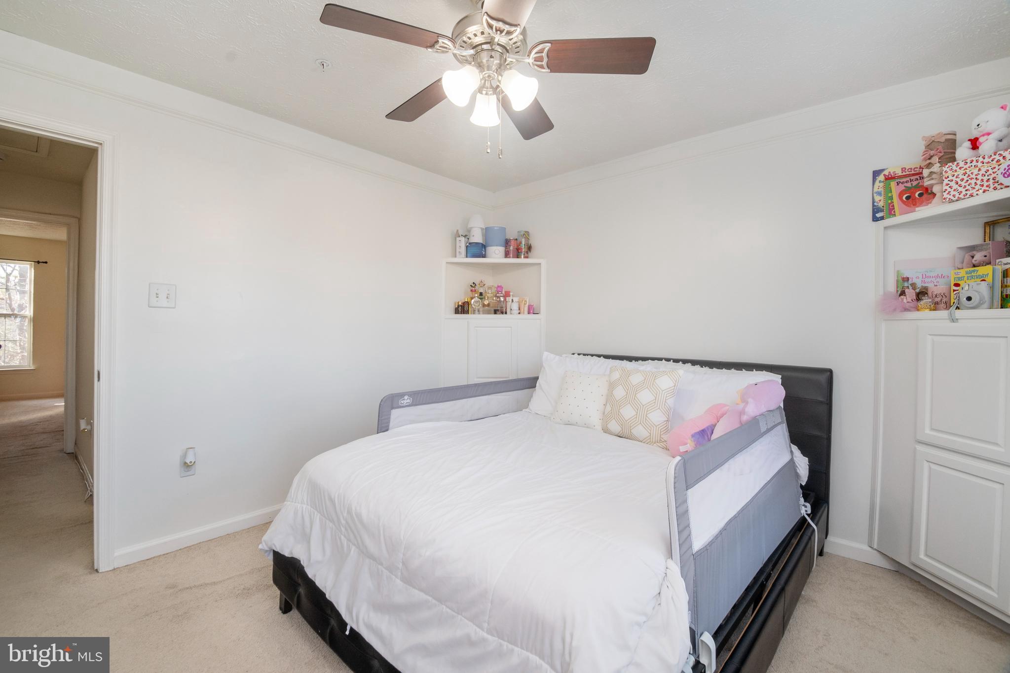 8310 Water Lily Way Laurel, MD 20724 - Photo 15 of 31 a bedroom with a bed and a chandelier