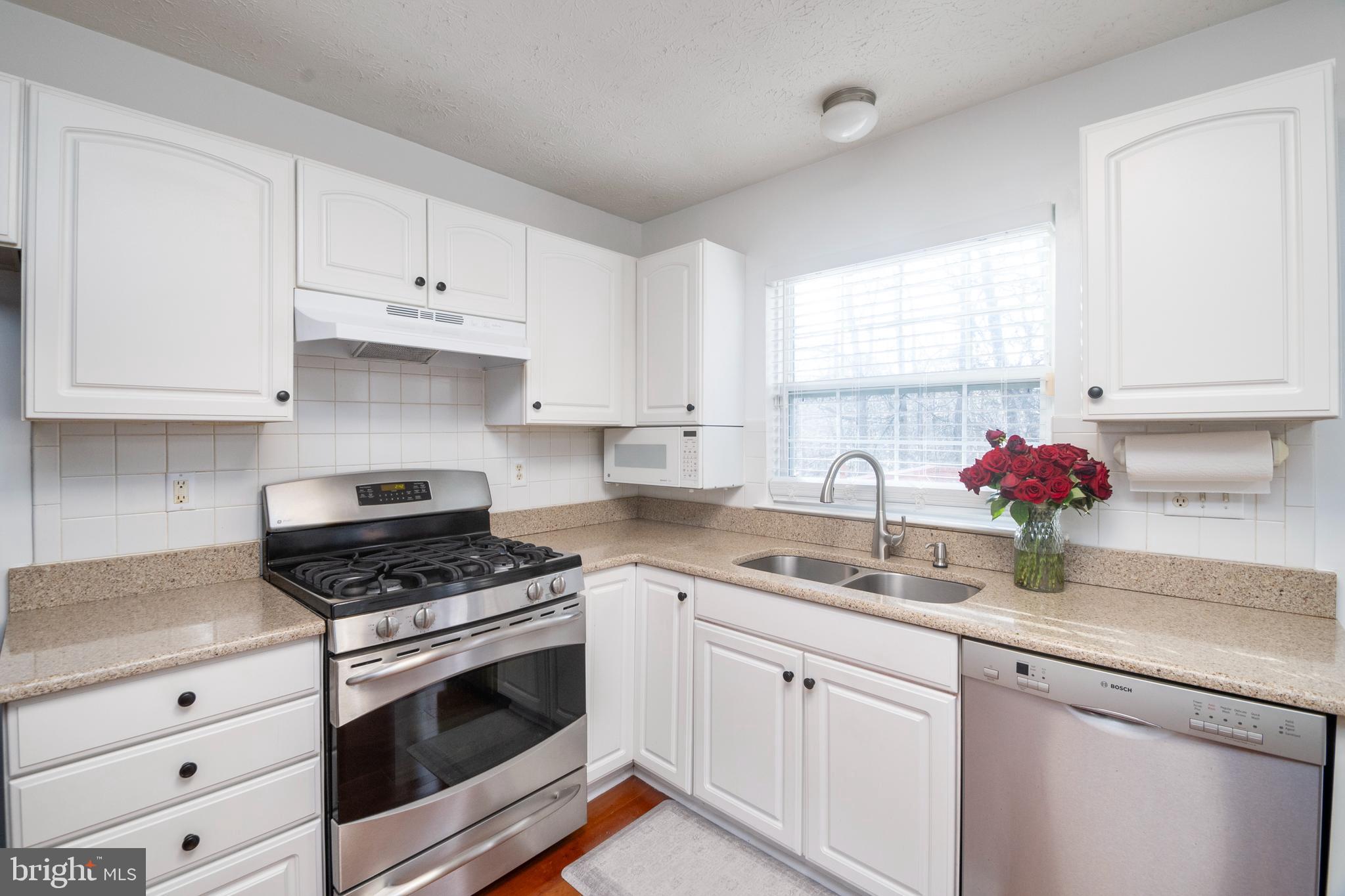 8310 Water Lily Way Laurel, MD 20724 - Photo 6 of 31 a kitchen with white cabinets sink and appliances