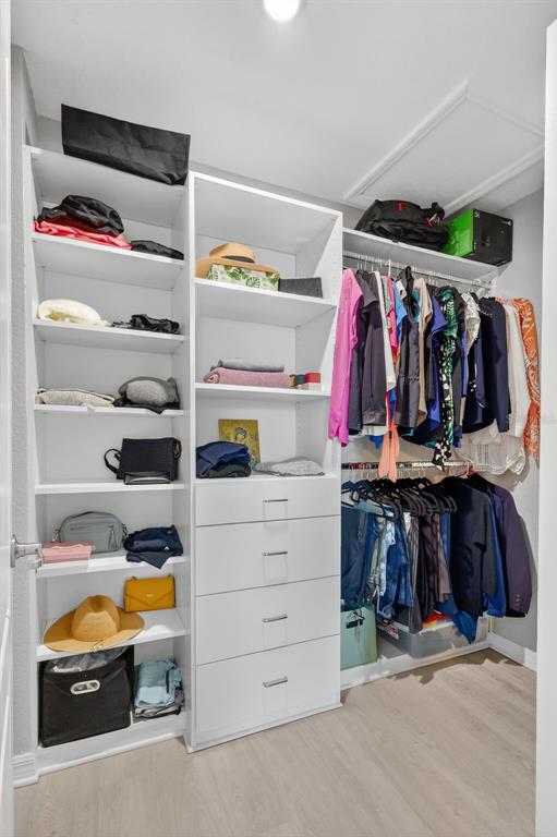 17619 Blue Rdg Place Bradenton, FL 34211 - Photo 41 of 98 a view of walk in closet with clothes and shoes
