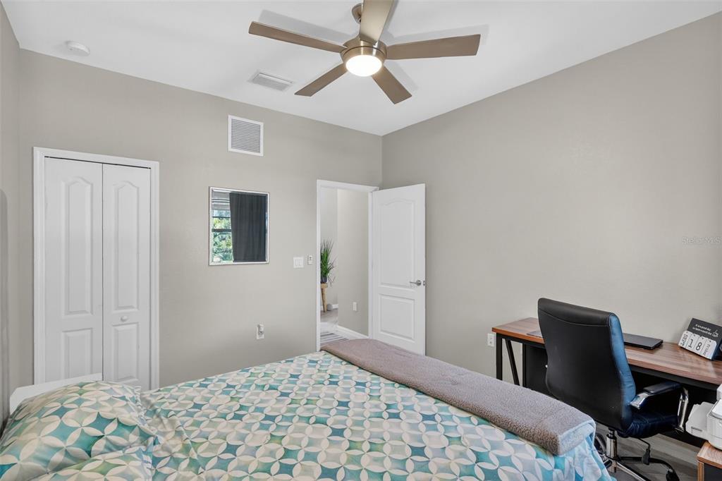17619 Blue Rdg Place Bradenton, FL 34211 - Photo 59 of 98 a bedroom with a bed and a chandelier