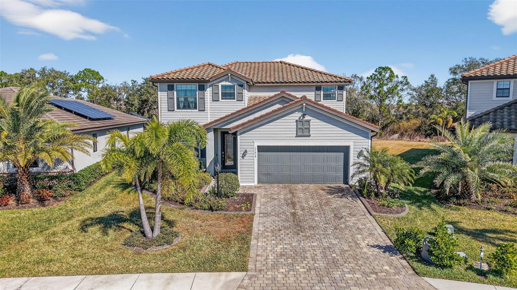 17619 Blue Rdg Place Bradenton, FL 34211 - Photo 60 of 98 a front view of a house with a yard and garage