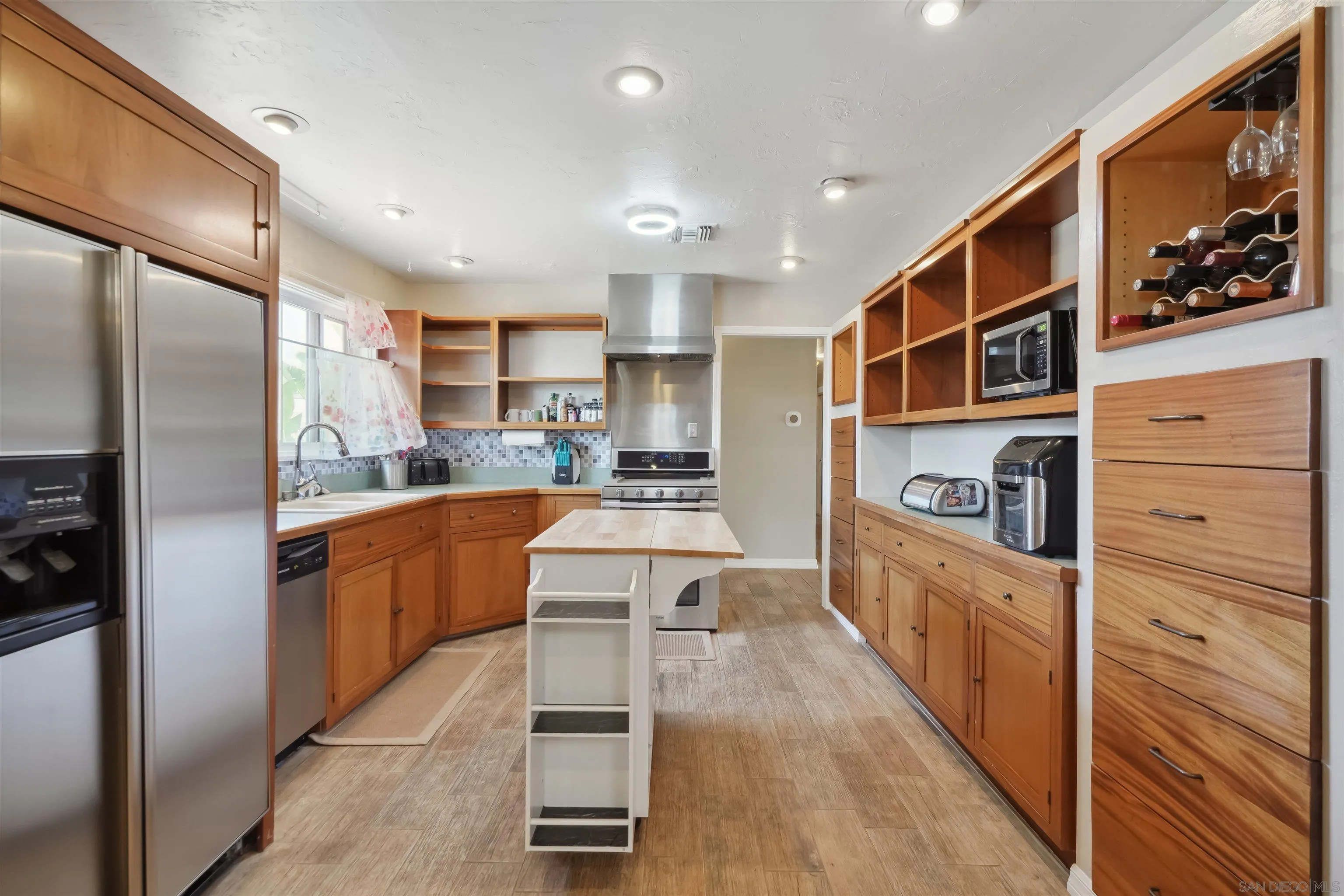 9537 East Hartland Circle Santee, CA 92071 - Photo 11 of 42 a kitchen with stainless steel appliances granite countertop a refrigerator and a stove top oven