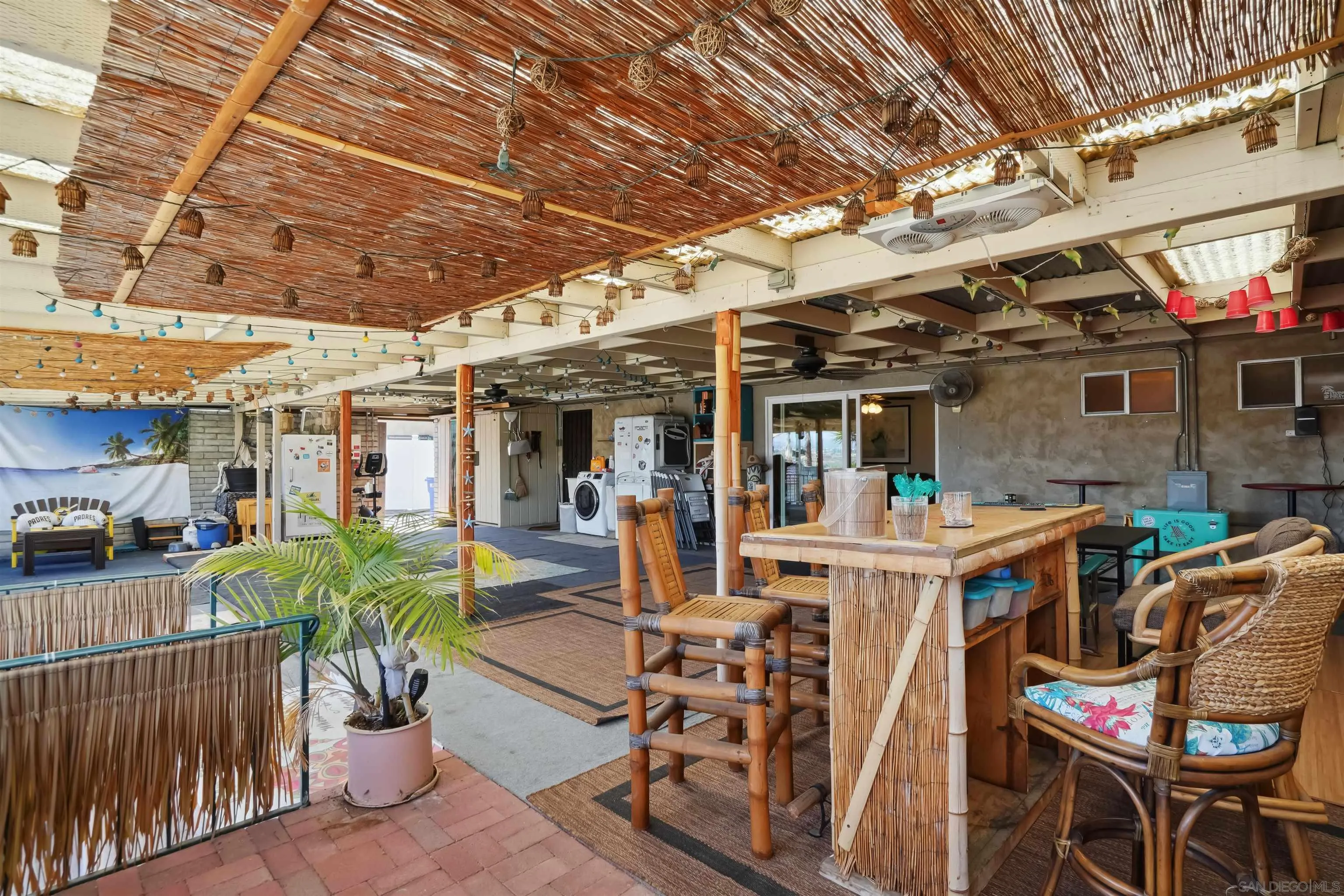 9537 East Hartland Circle Santee, CA 92071 - Photo 19 of 42 a view of a patio with table and chairs potted plants with wooden floor and fence