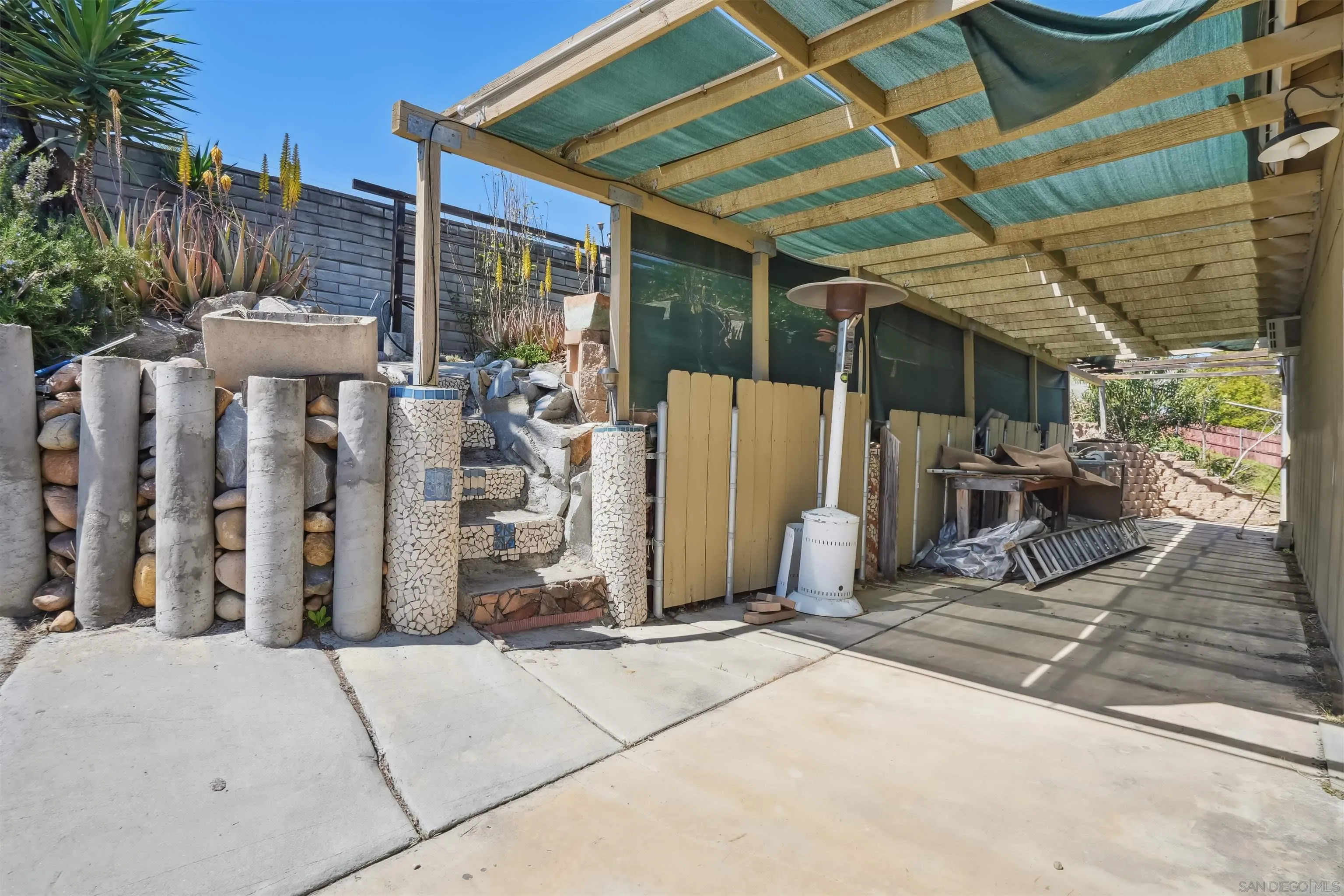 9537 East Hartland Circle Santee, CA 92071 - Photo 30 of 42 a view of a patio with table and chairs a barbeque with wooden fence