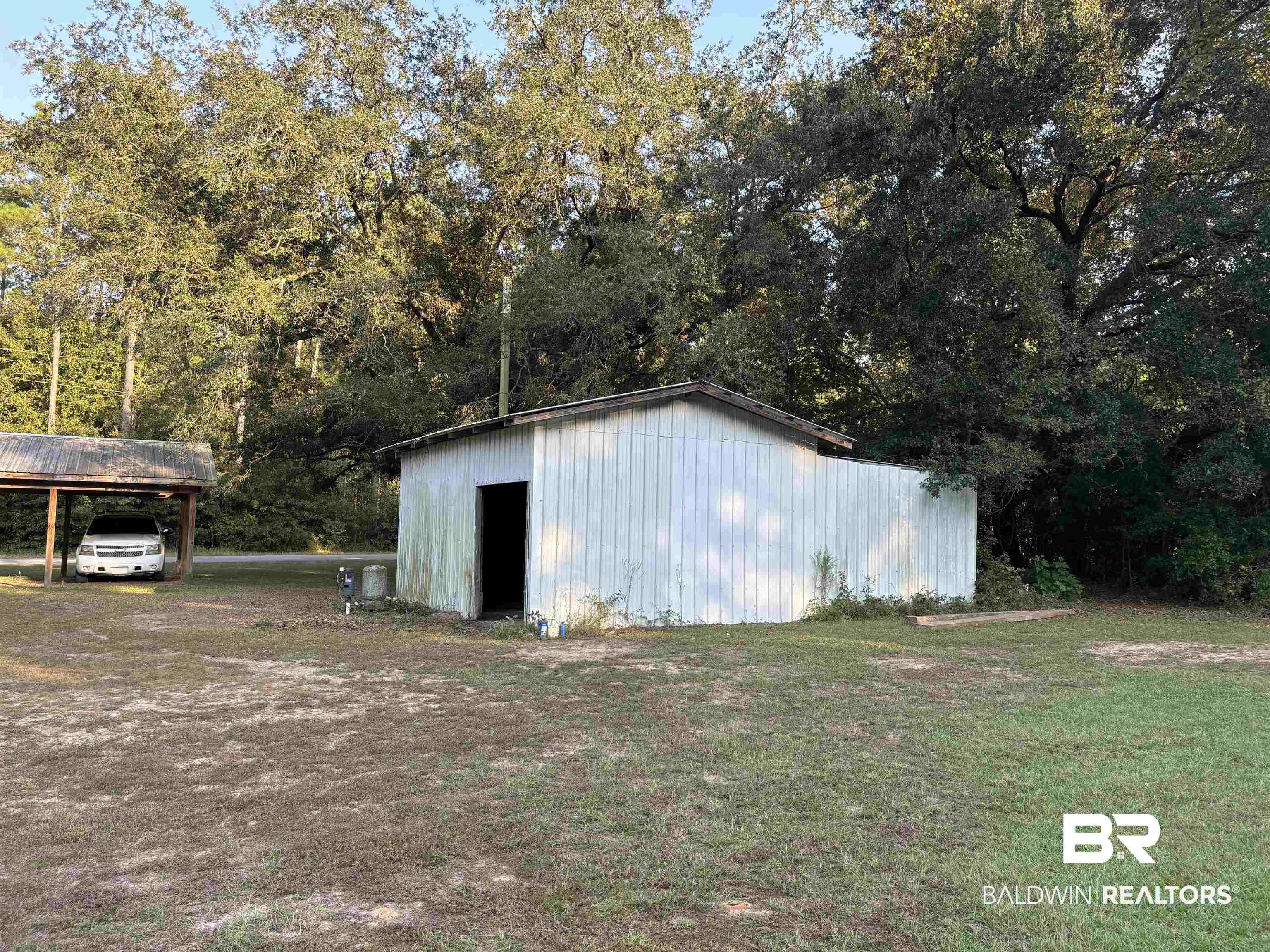 17495 County Road 48 Robertsdale, AL 36567 - Photo 13 of 37 View of outdoor structure with a carport and a lawn